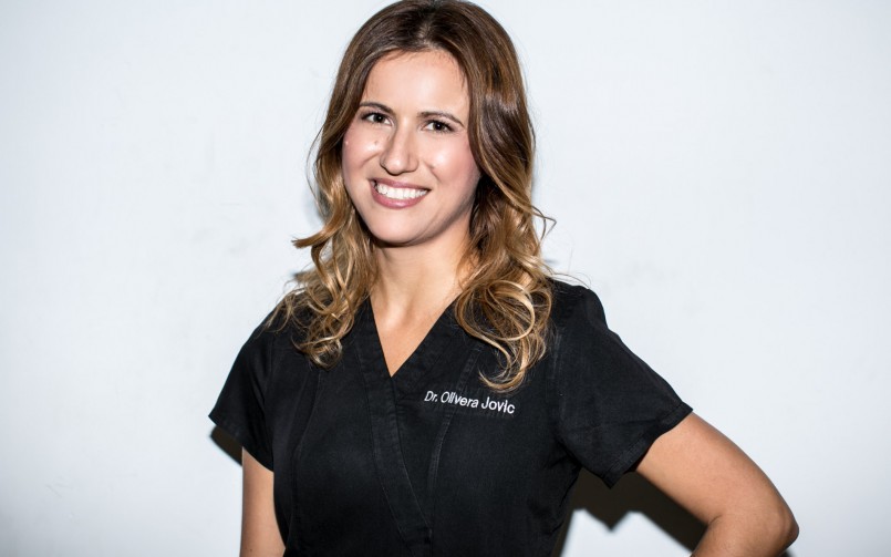 A woman in black shirt smiling for the camera.