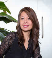 A woman in black shirt and long hair.