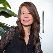 A woman in black shirt and long hair.
