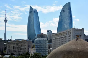 Here's a short alt tag for the image: `Baku skyline with Flame Towers`
