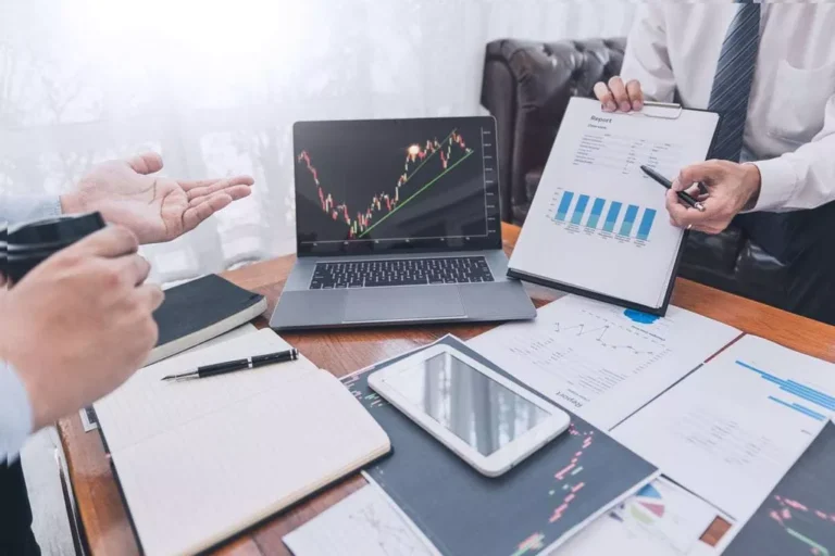 Businessmen reviewing financial data and charts.