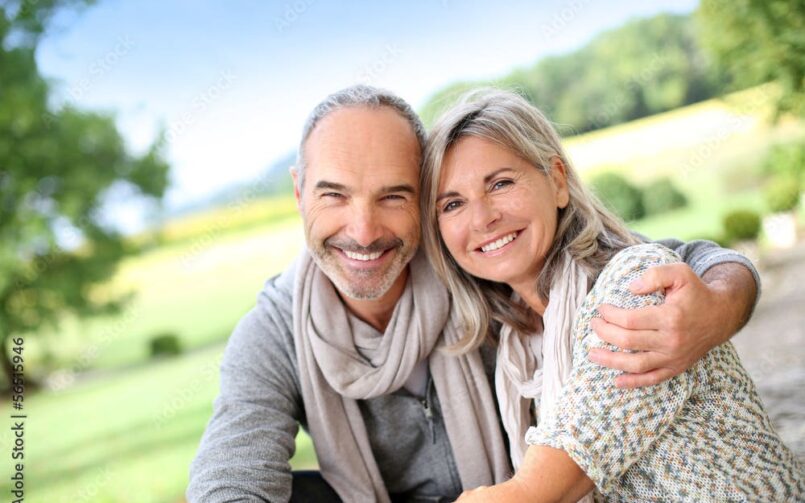 Happy senior couple embracing outdoors.